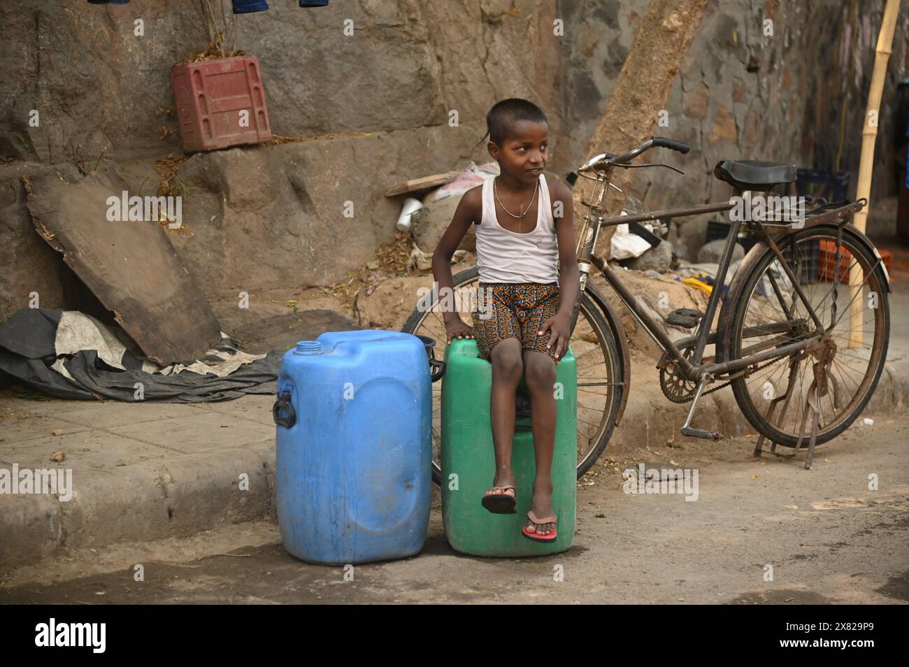 Delhi, New Delhi, India. 22nd May, 2024. A boy waits for the municapl tanker to come on a hot summer day in New Delhi, India on May 22, 2024 (Credit Image: © Deep Nair/ZUMA Press Wire) EDITORIAL USAGE ONLY! Not for Commercial USAGE! Stock Photo