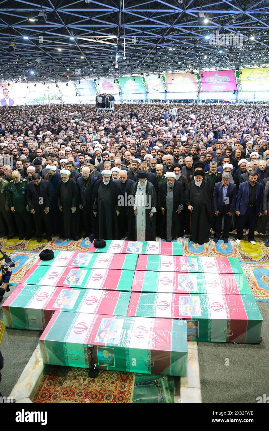 Tehran, Iran. 22nd May, 2024. Iran's Supreme Leader Ayatollah ALI KHAMENEI (C) and other clerics and officials praying over the coffins of late Iranian President Ebrahim Raisi and others, including Foreign Minister Hossein Amir-Abdollahian, in Tehran. Huge crowds of Iranians thronged the streets of the capital, Tehran, on May 22 for the funeral procession of President Ebrahim Raisi and his entourage, who died in a helicopter crash. (Credit Image: © Iranian Supreme Leader'S Office via ZUMA Press Wire) EDITORIAL USAGE ONLY! Not for Commercial USAGE! Stock Photo