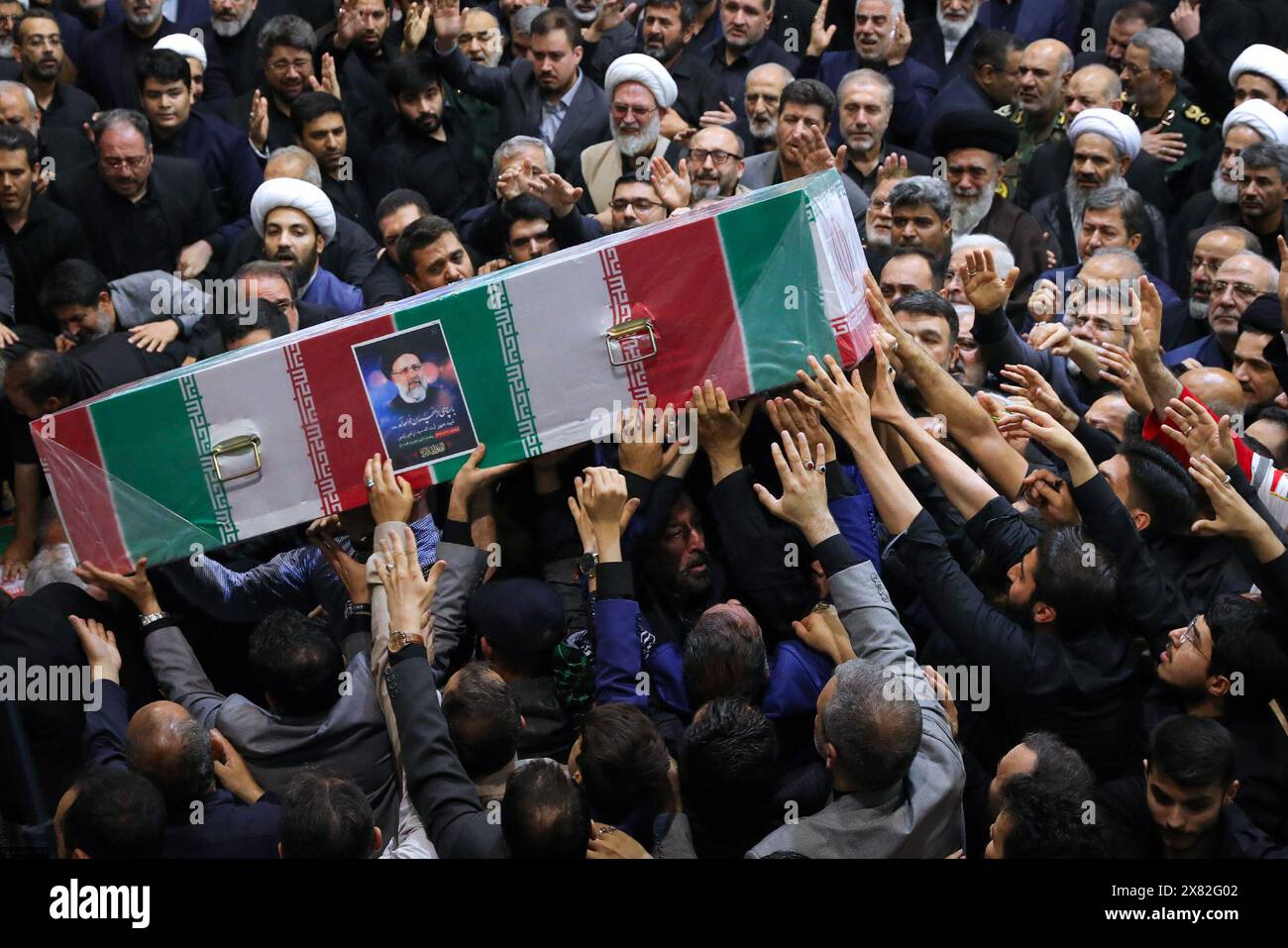 Tehran, Iran. 22nd May, 2024. Iranians carry the coffins of late Iranian President Ebrahim Raisi and others, including Foreign Minister Hossein Amir-Abdollahian, in Tehran. Huge crowds of Iranians thronged the streets of the capital, Tehran, on May 22 for the funeral procession of President Ebrahim Raisi and his entourage, who died in a helicopter crash. (Credit Image: © Iranian Supreme Leader'S Office via ZUMA Press Wire) EDITORIAL USAGE ONLY! Not for Commercial USAGE! Stock Photo