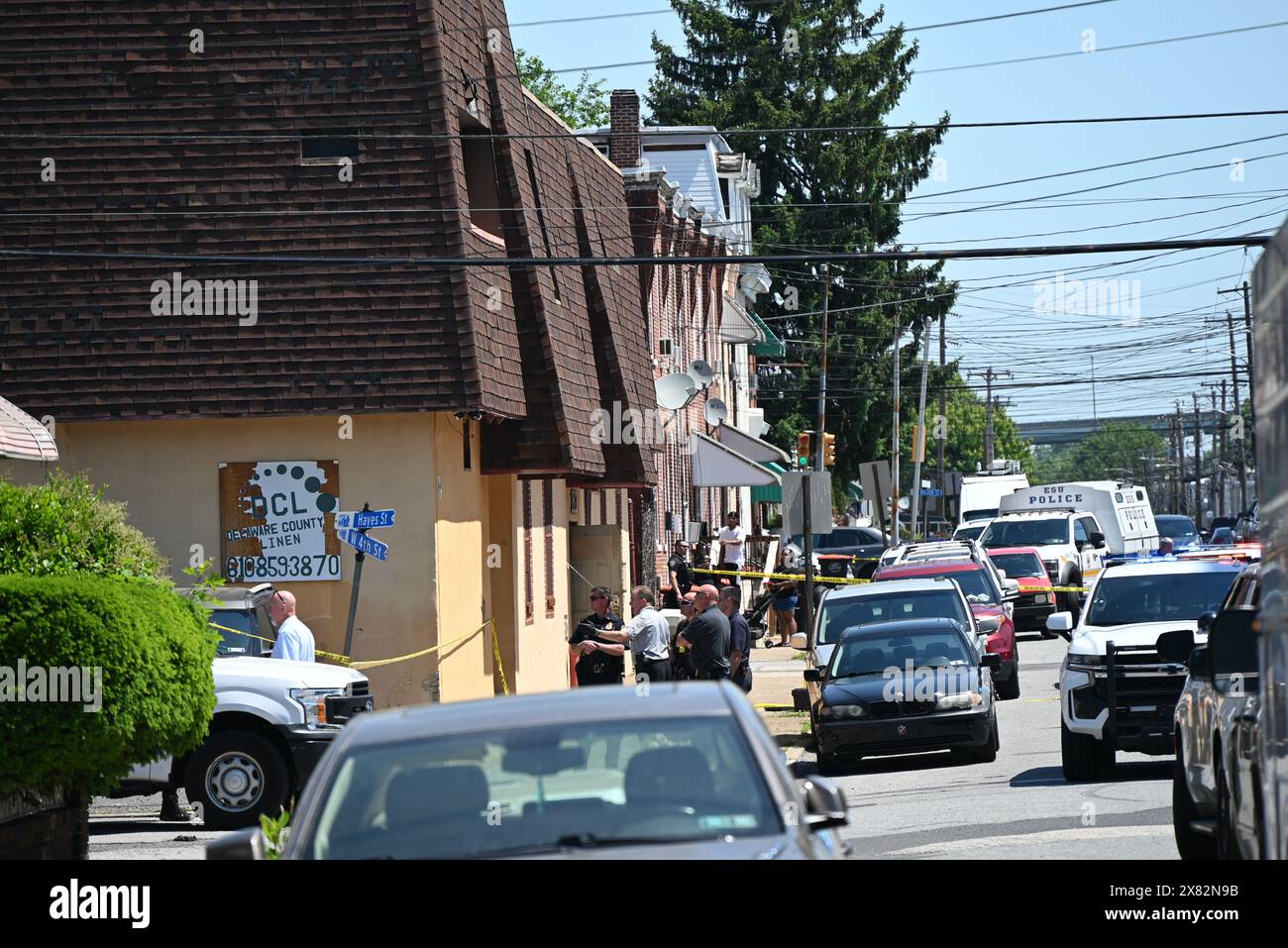 Chester, Pennsylvania, USA. 22nd May, 2024. Multiple police officers converge at the scene, Wednesday where 2 people are dead and three people are injured in a workplace shooting at Delaware County Linen on the 2600 block of W. 4th Street in Chester. The suspect involved in the mass shooting was captured by police. (Credit Image: © Kyle Mazza/SOPA Images via ZUMA Press Wire) EDITORIAL USAGE ONLY! Not for Commercial USAGE! Stock Photo