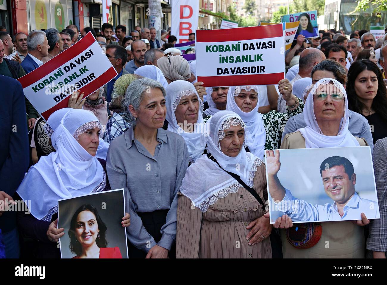 May 22, 2024, Diyarbakir, Turkey: Democratic Regions Party (DBP) Co-Chairman Cigdem Kilicgun Ucar (L2) is seen with Kurdish women carrying posters of Selahattin Demirtas and Figen Yuksekdag during the demonstration. The long prison sentences given to some Kurdish politicians in Turkey were protested with a march and press statement organized by the People's Equality and Democracy Party (DEM Party), Democratic Regions Party (DBP) and the Free Women's Movement (TJA-Tevgera JinÃªn Azad) organization in Diyarbakir. Many police officers were seen during the protest, but despite the obstacle from th Stock Photo