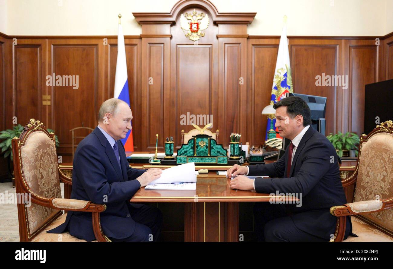 Moscow, Russia. 21st May, 2024. Russian President Vladimir Putin listens to Kalmykia Republic head Batu Khasikov, right, during face-to-face meeting at the Kremlin, May 21, 2024, in Moscow, Russia. Credit: Alexander Kazakov/Kremlin Pool/Alamy Live News Stock Photo