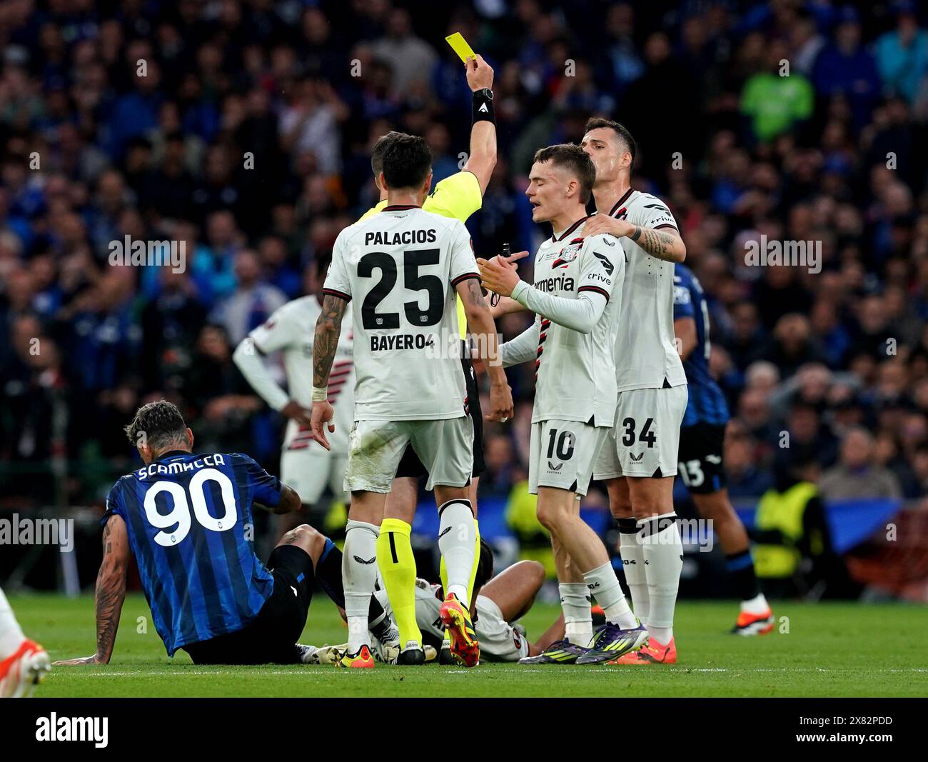 Bayer Leverkusen's Florian Wirtz (10) is shown a yellow card during the