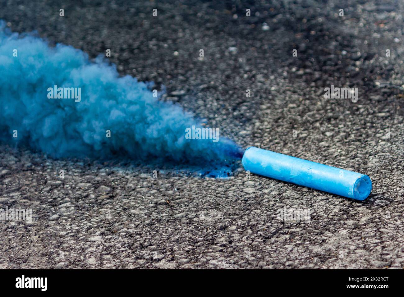 Fiery blue smoke intertwines with dangerous outdoor fireworks and hints of pollution Stock Photo