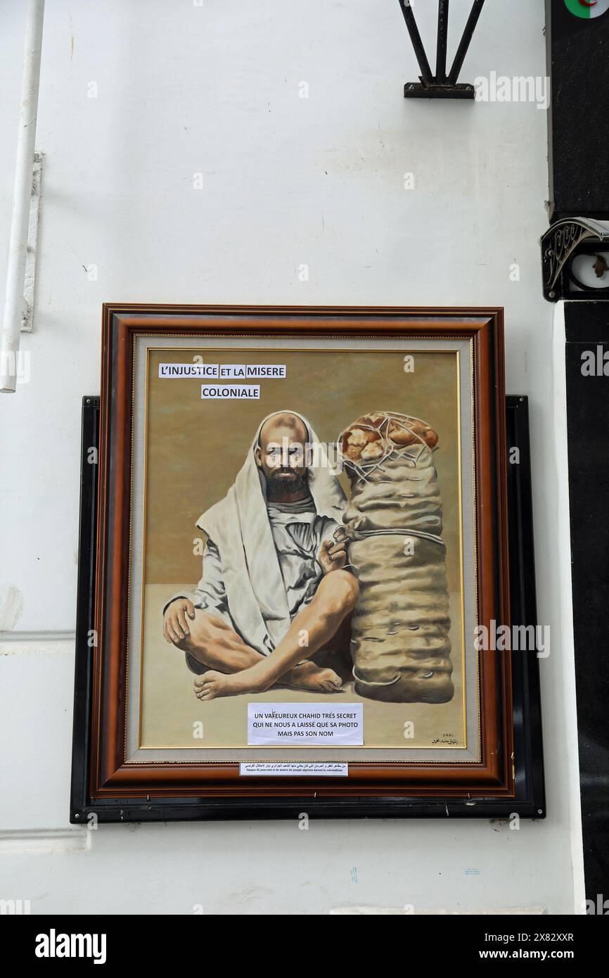Colonial injustice painting displayed on the street in Algiers Stock Photo
