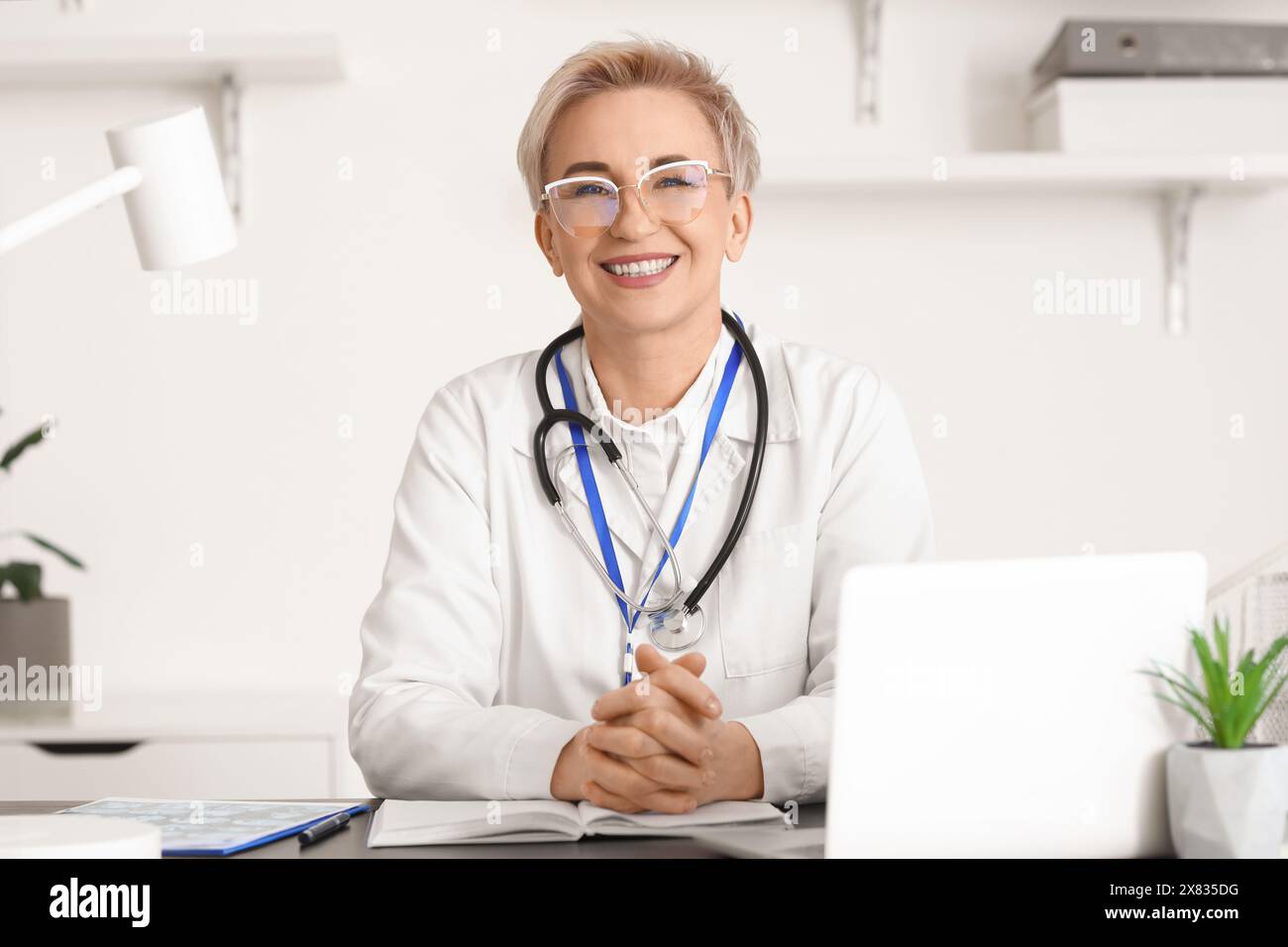 Mature female doctor at workplace in clinic Stock Photo - Alamy