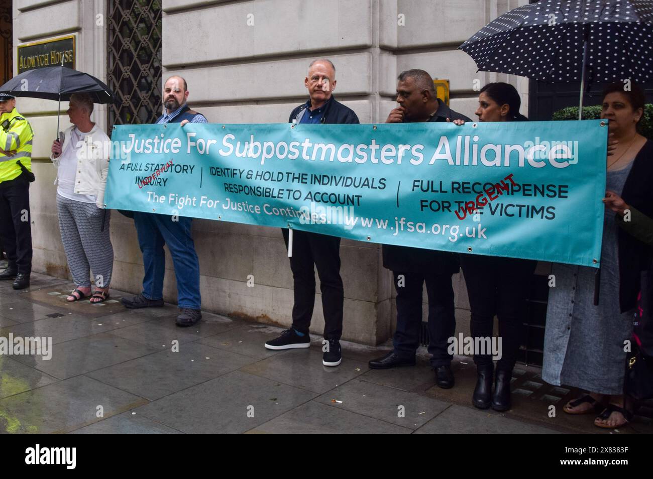 London, UK. 22nd May 2024. Protesters hold a 'Justice For Subpostmasters Alliance' banner outside Aldwych House during the hearing with former Post Office CEO Paula Vennells as the Post Office Horizon IT Inquiry continues. Credit: Vuk Valcic/Alamy Live News Stock Photo