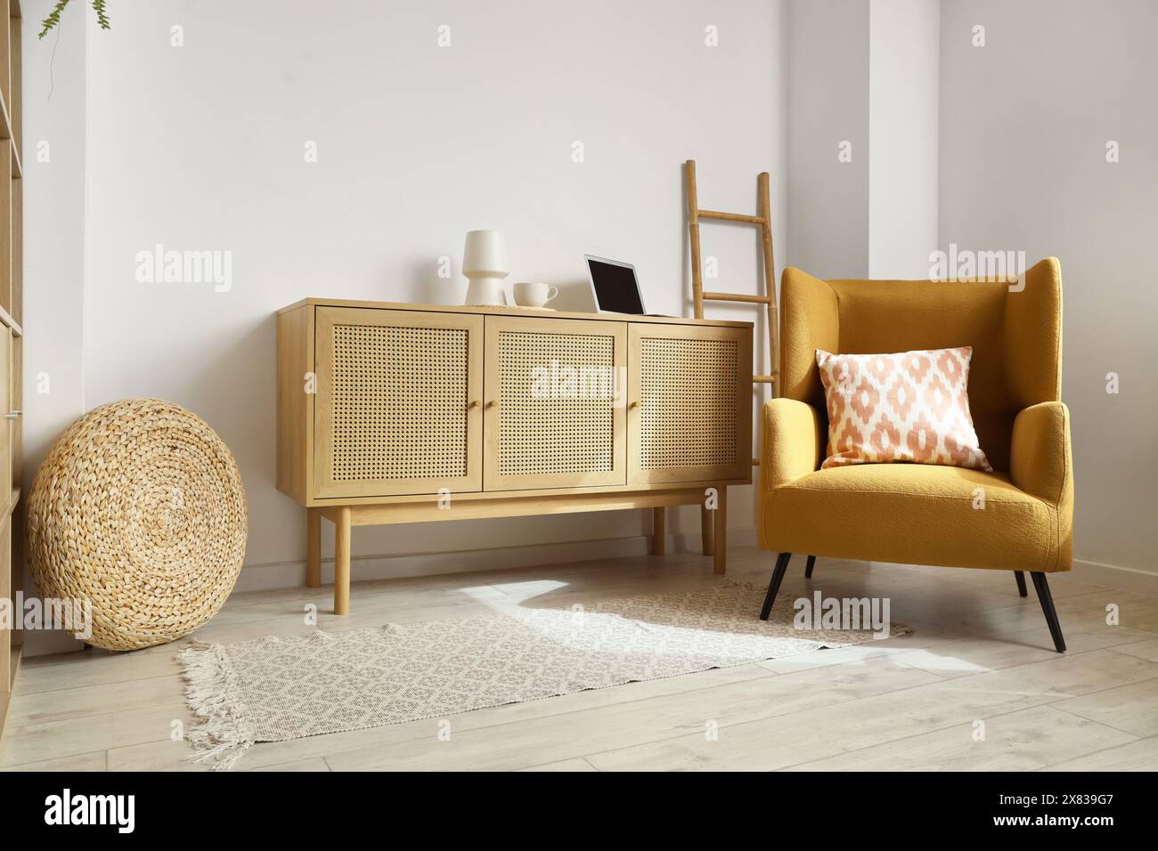 Interior of living room with armchair and wooden commode Stock Photo ...