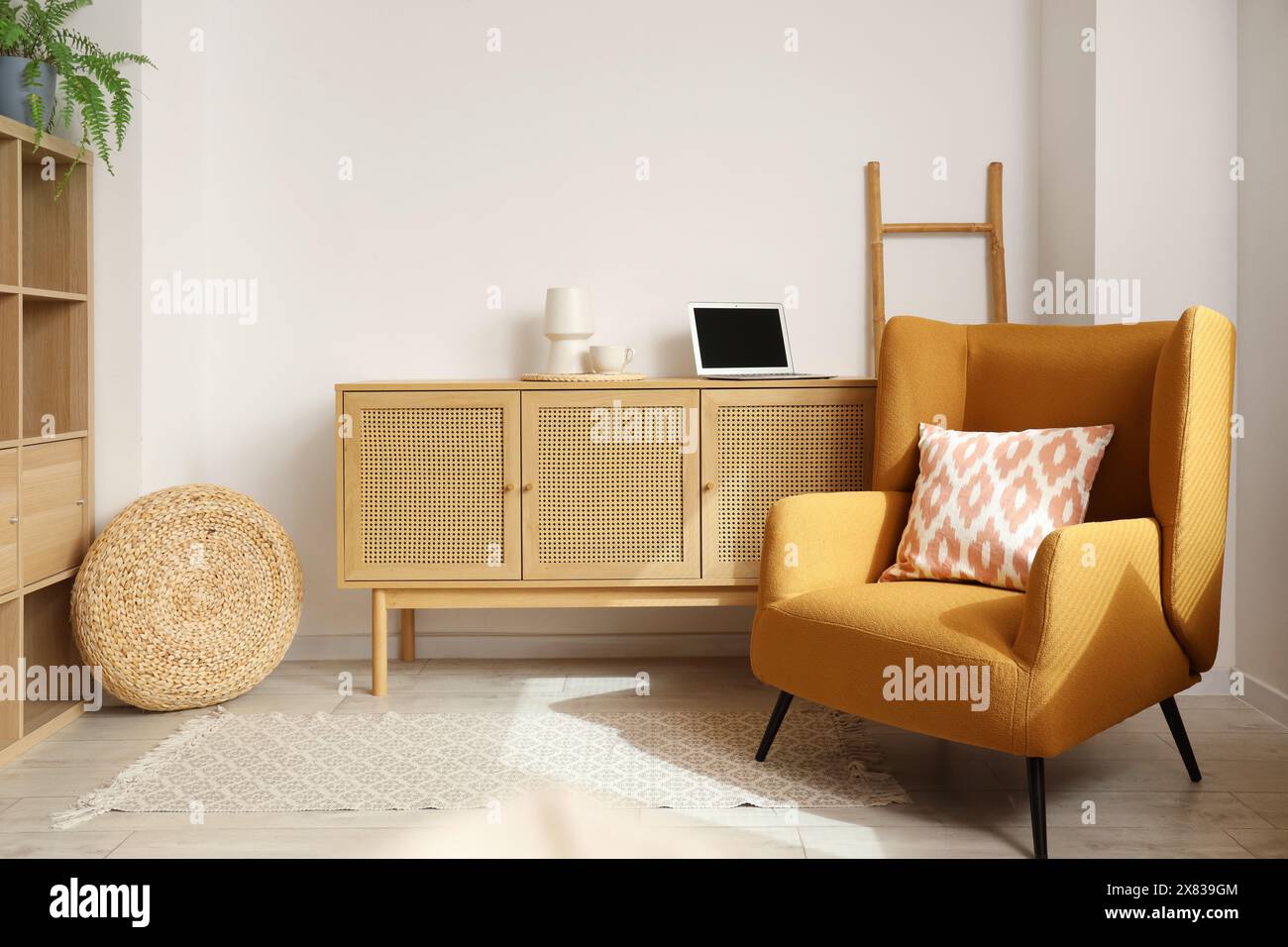 Interior of living room with armchair and wooden commode Stock Photo ...