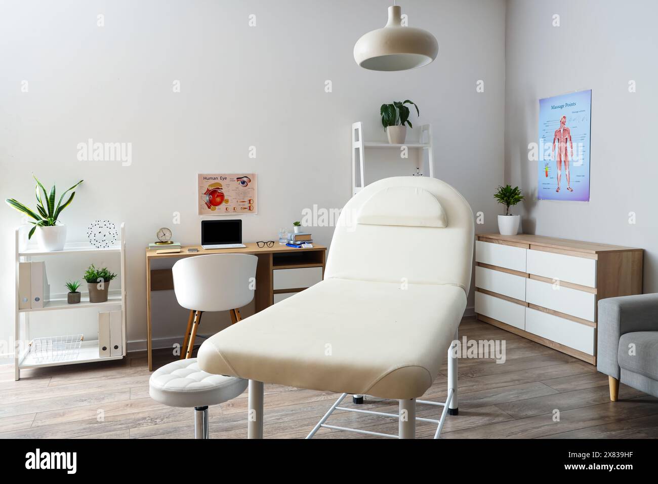 Interior of medical office with couch, drawers and doctor's workplace ...