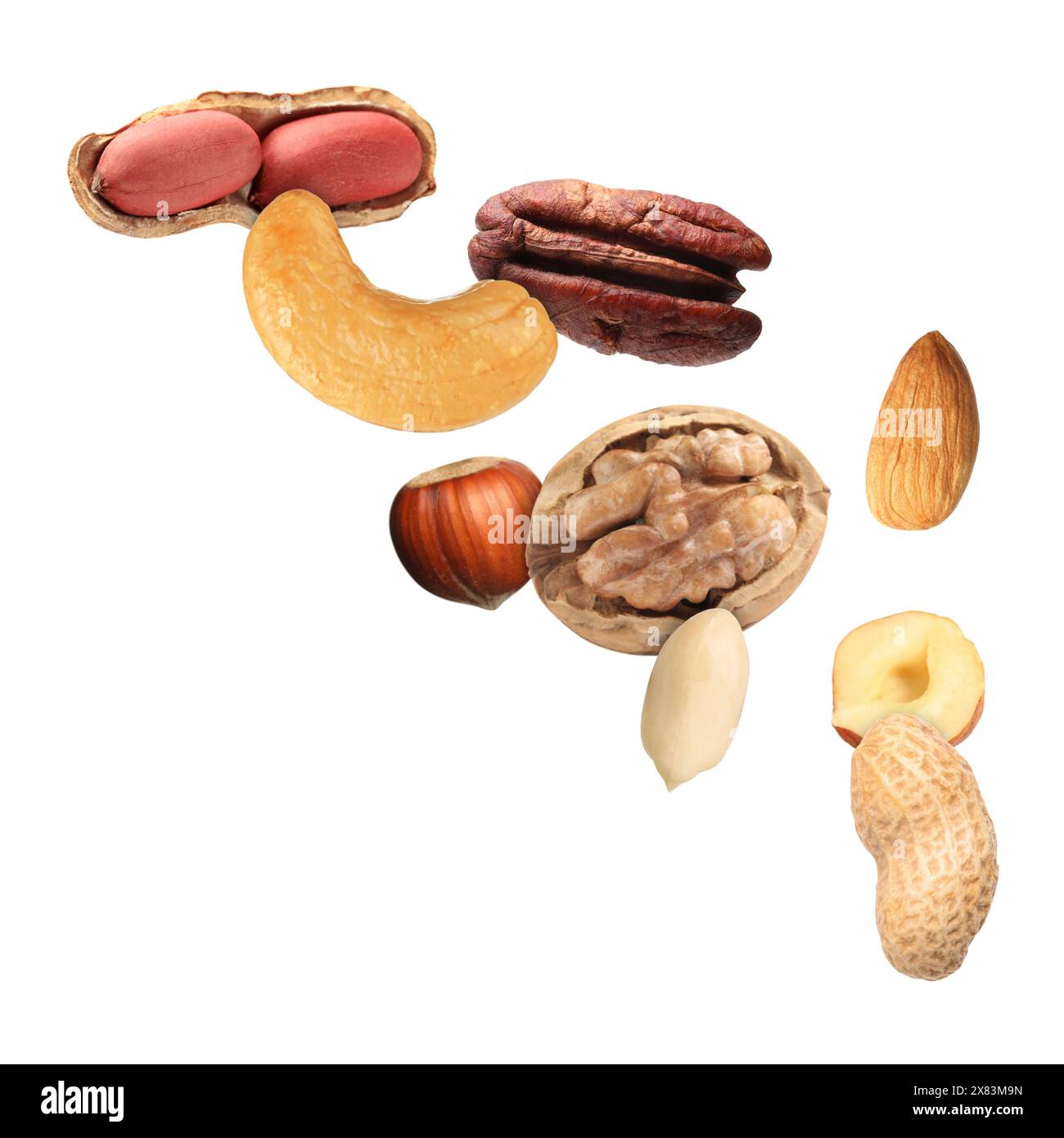 Many different nuts in air on white background Stock Photo