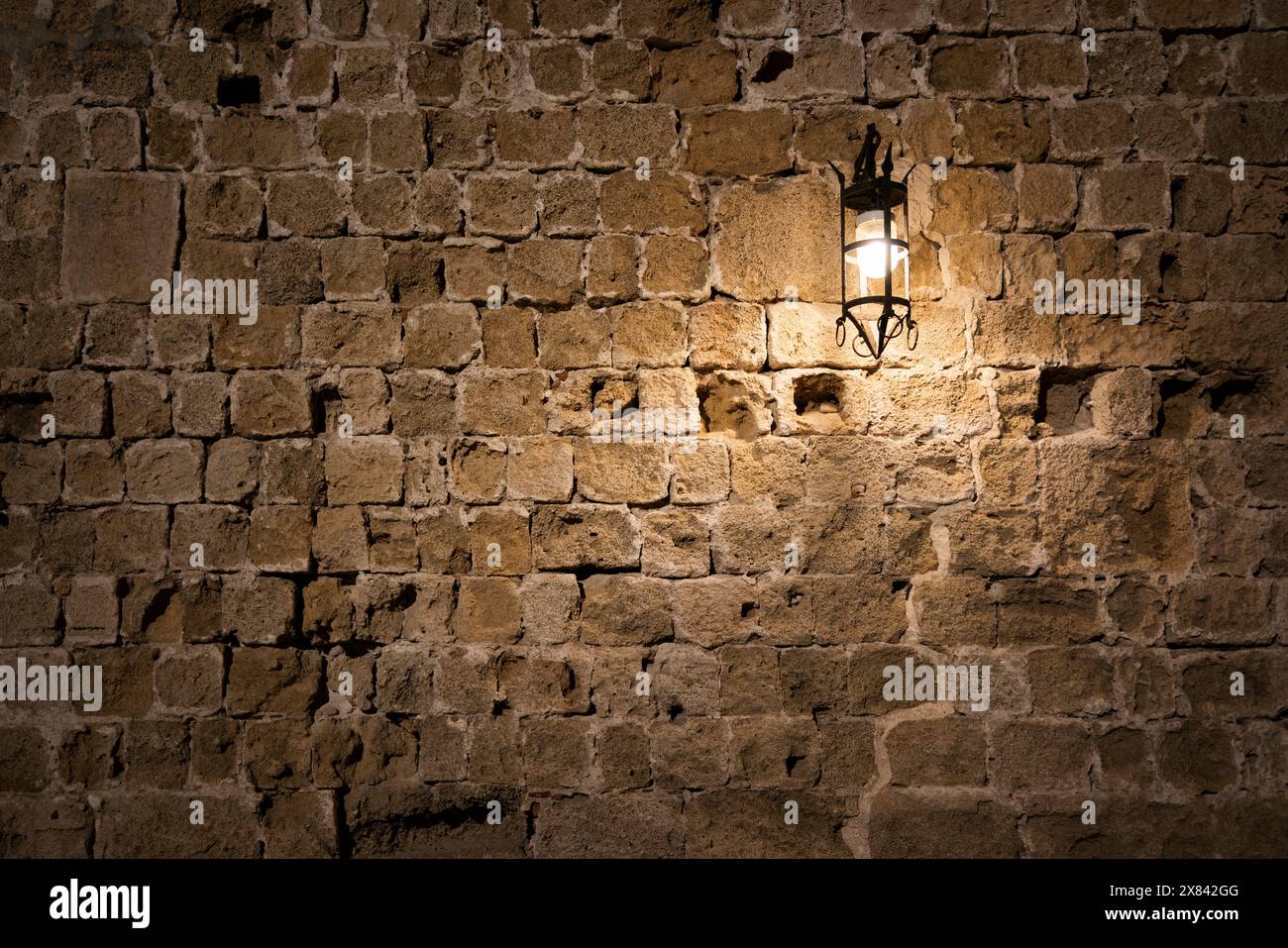 Dark brick wall background with an old lantern. Stock Photo