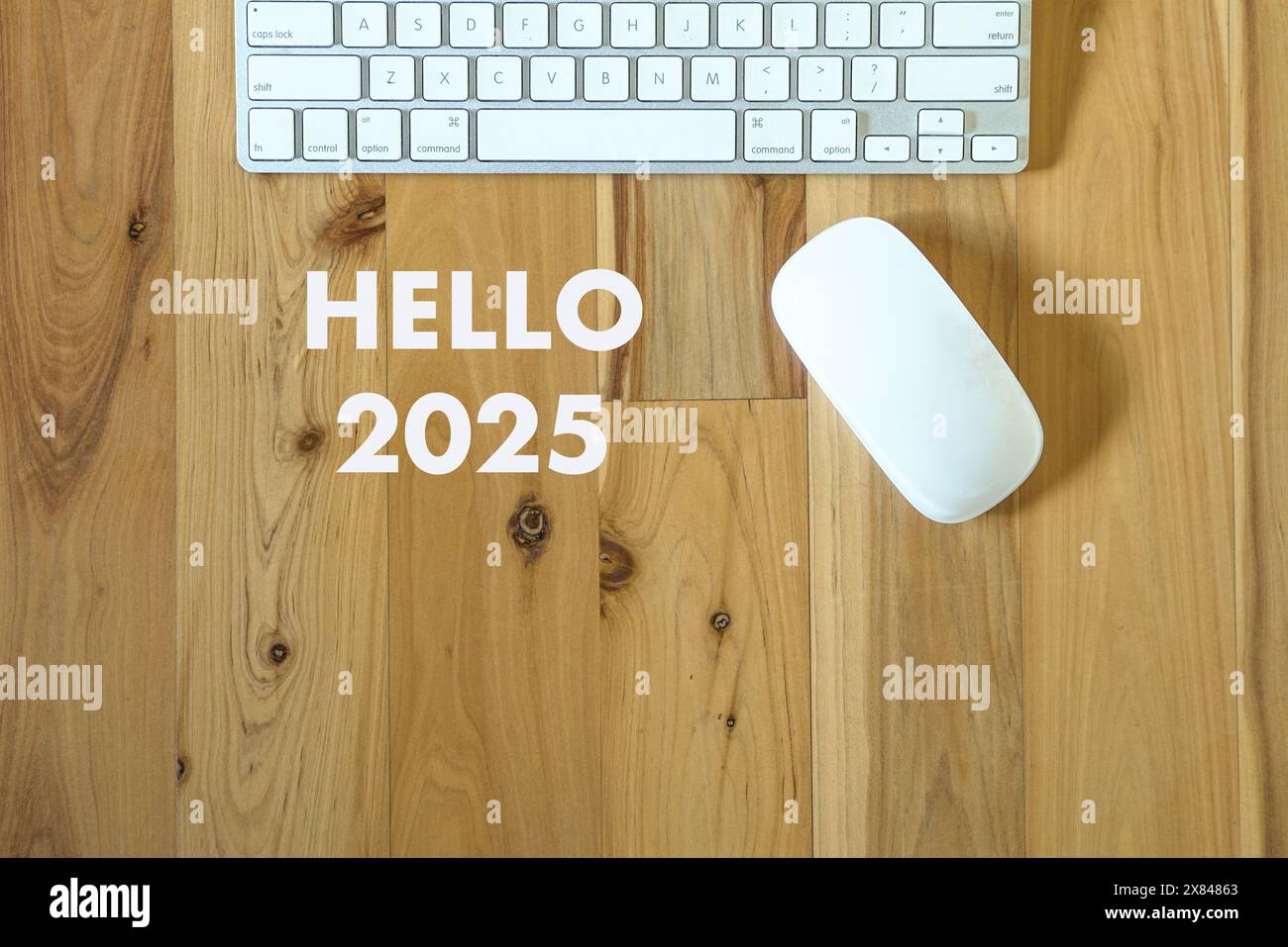 Hellow 2025, text next to computer keyboard and mouse. Top view. Stock Photo