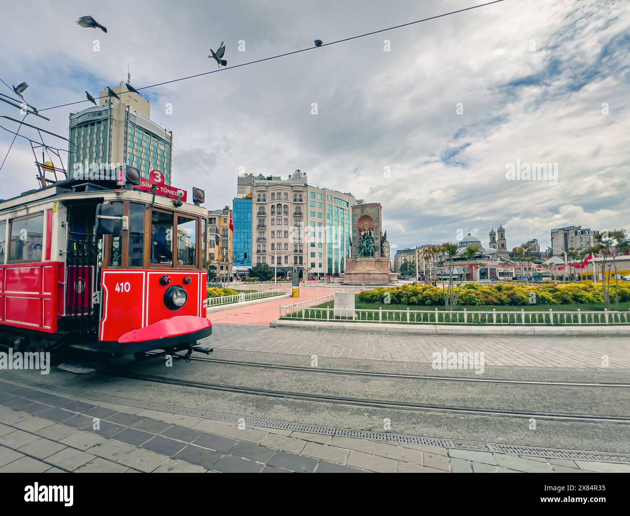 Ataturk statue and nostalgic tram in Taksim square in Istanbul Stock Photo