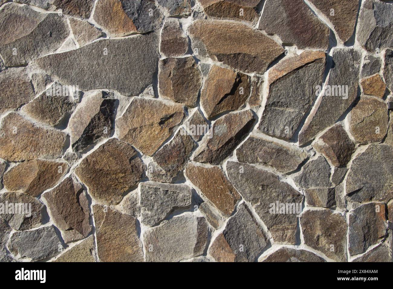 natural stone on the wall glued with gray Stock Photo - Alamy