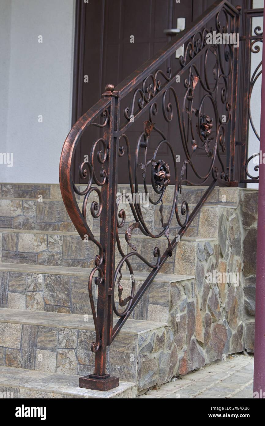 stone stairs and tiles with wrought iron railings and doors to the ...