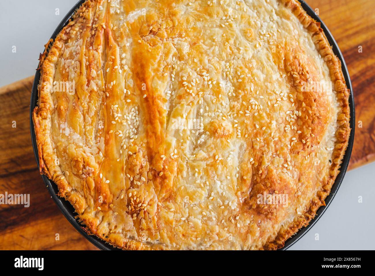 homemade round puff pastry pie in style of a sheperd's pie with sesame ...