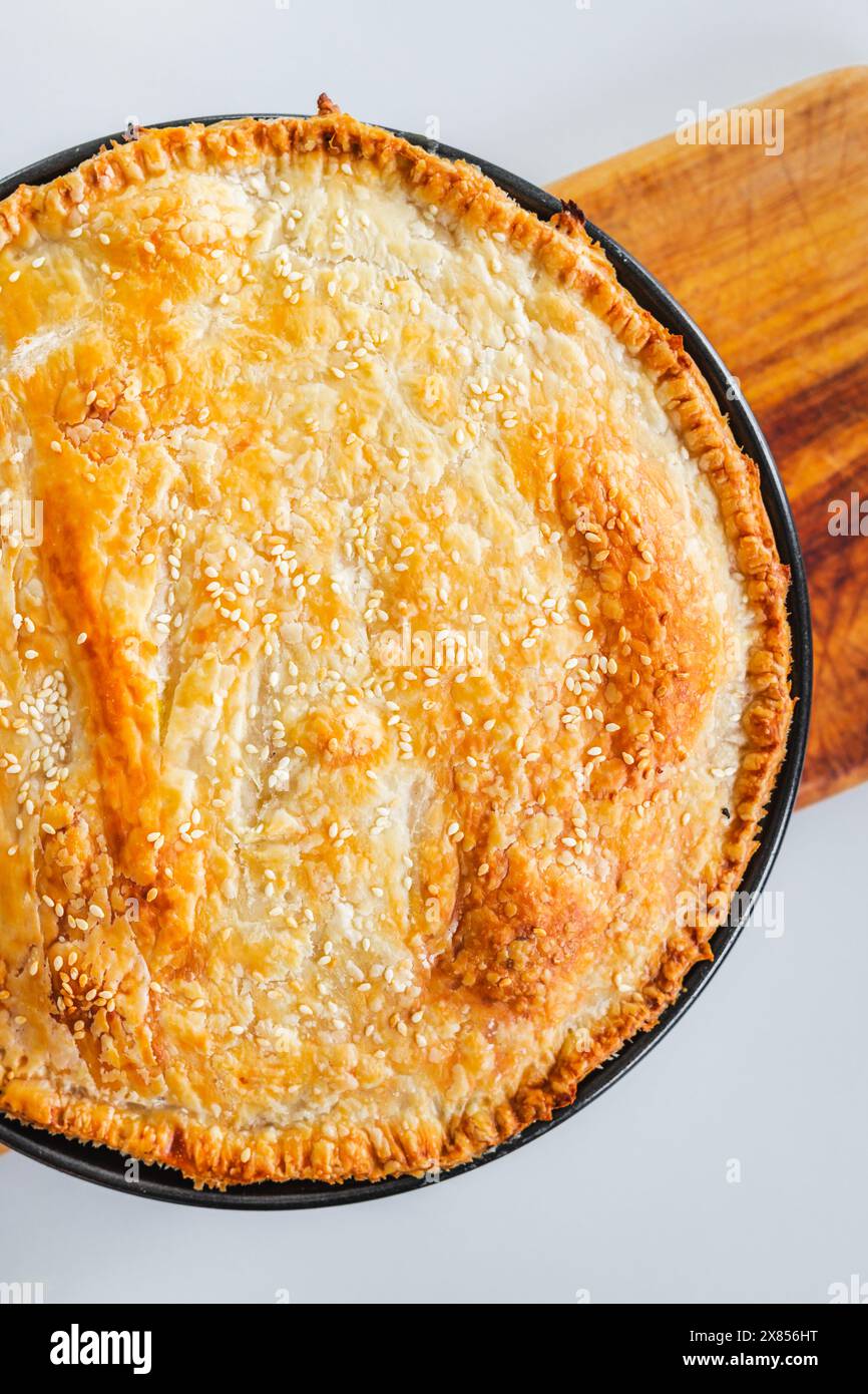homemade round puff pastry pie in style of a sheperd's pie with sesame ...
