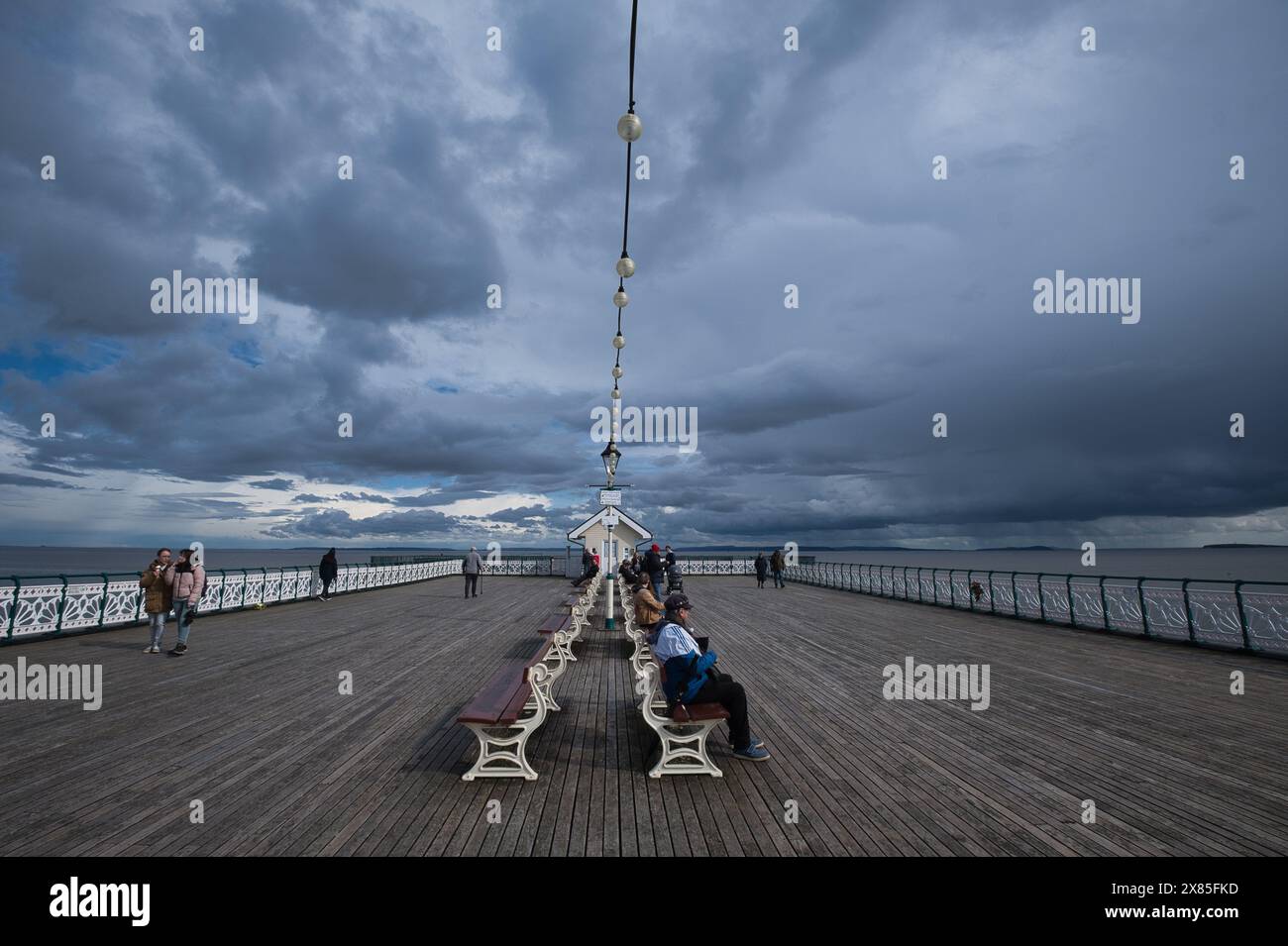 Storm clouds gather over  Penarth Pier in early Spring Stock Photo