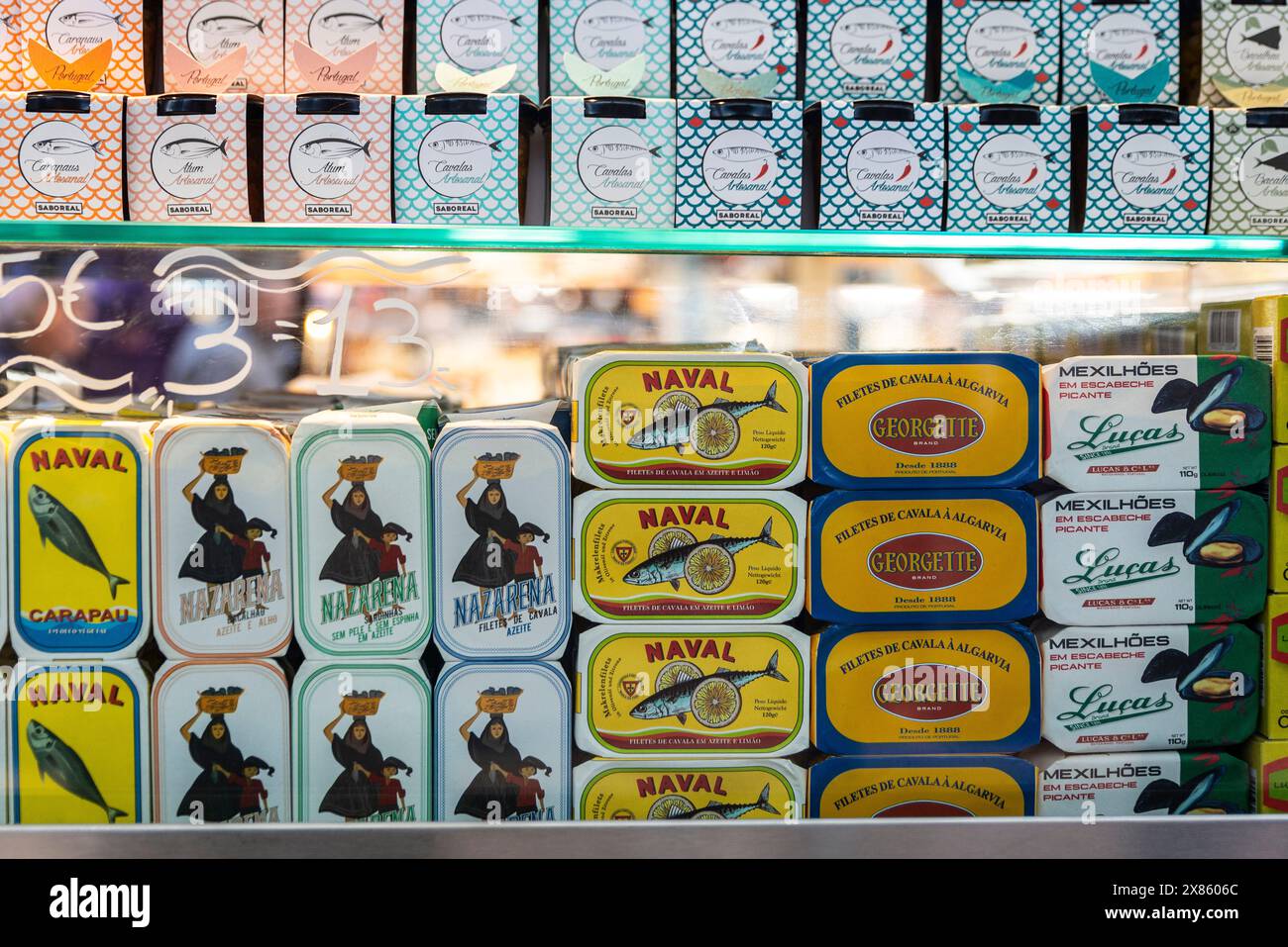 Oporto, Portugal - November 23, 2023: Cans of preserves of tuna, mussel, sardines and mackerel in a gourmet shop in Bolhao Market, street food market Stock Photo