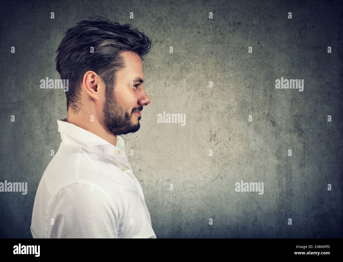 Side profile portrait of a cheerful smiling unshaved handsome man Stock Photo