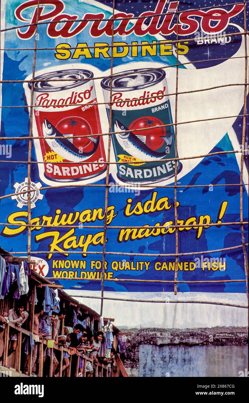 Philippines, Manila; billboard advertising for paradiso sardines iin a poor area of town. Stock Photo