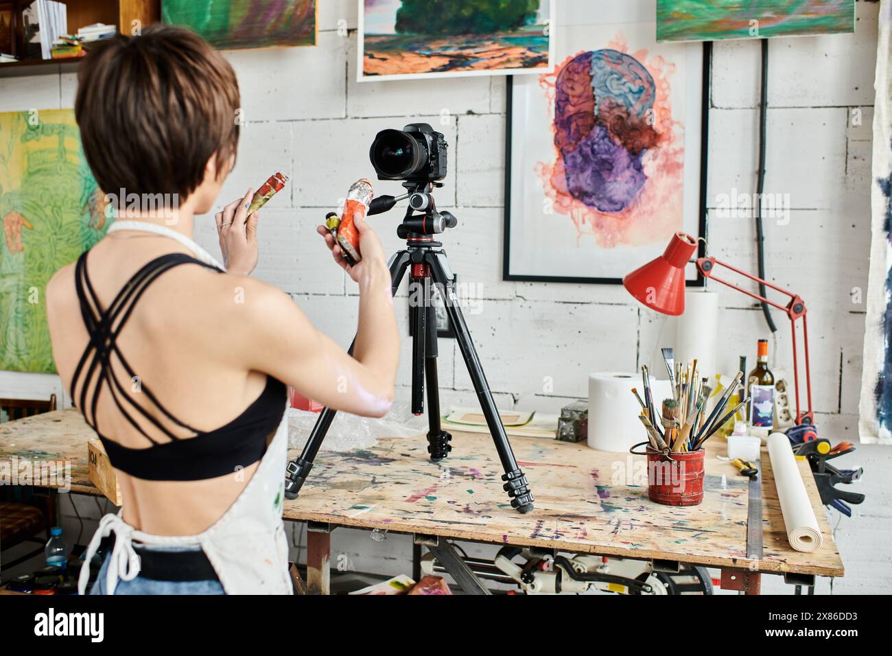 A woman teaching how to paint on camera Stock Photo - Alamy