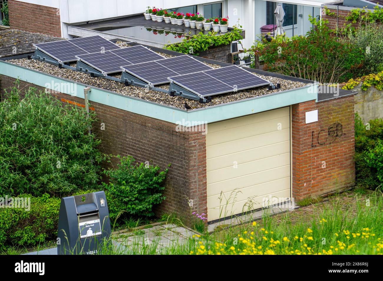 Solar modules on roofs, here on a car garage, Vlissingen, Netherlands, Stock Photo