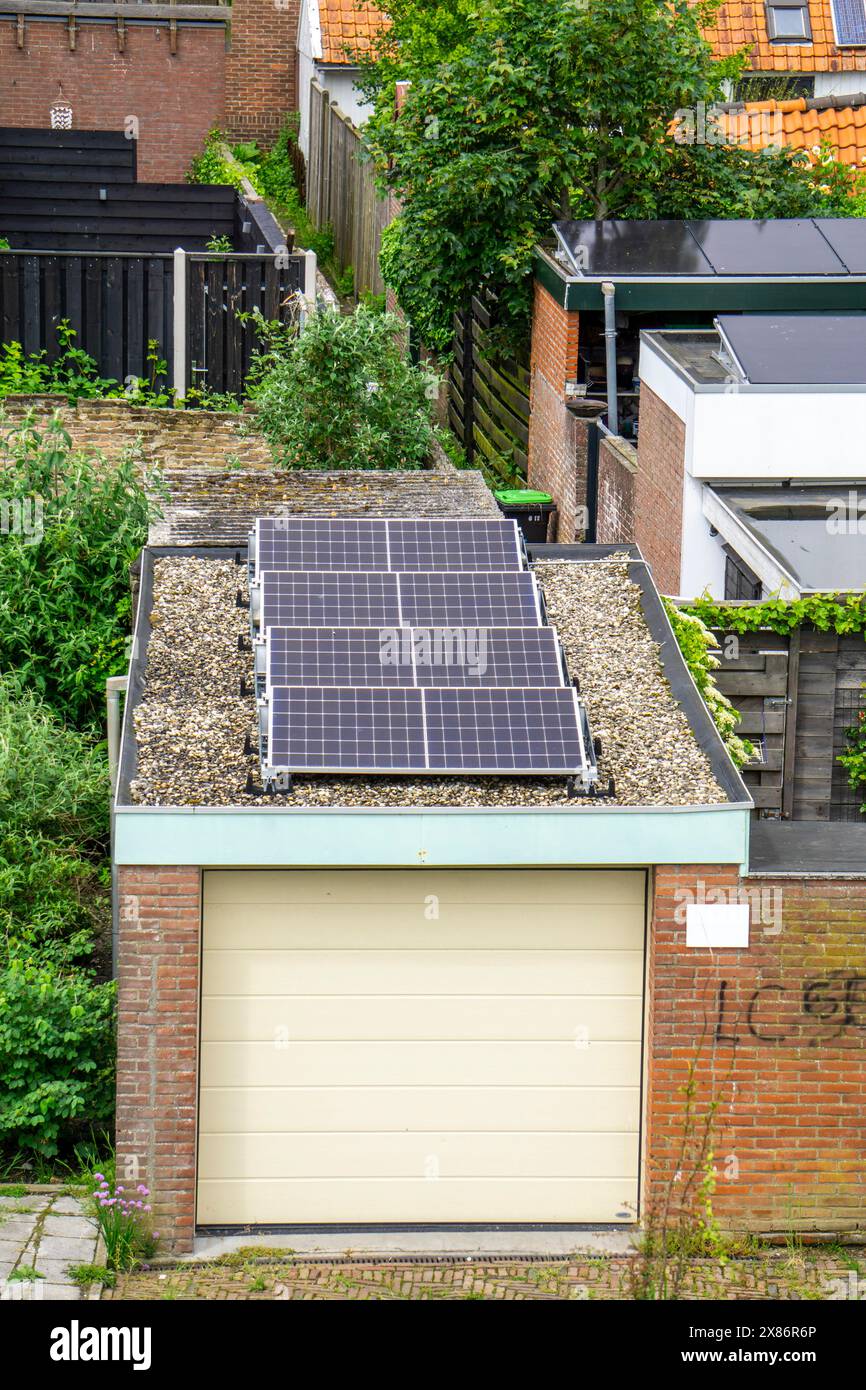 Solar modules on roofs, here on a car garage, Vlissingen, Netherlands, Stock Photo