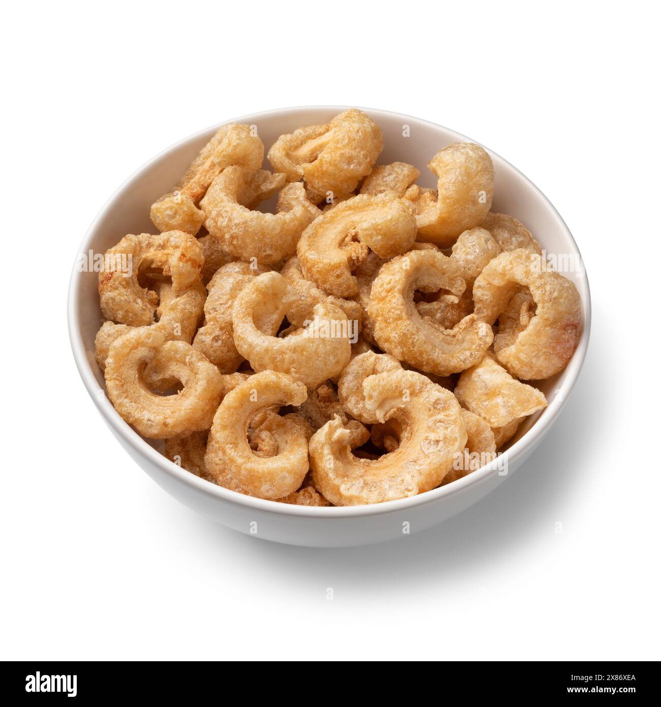 Bowl with traditional fried pork rind isolated on white background close up Stock Photo