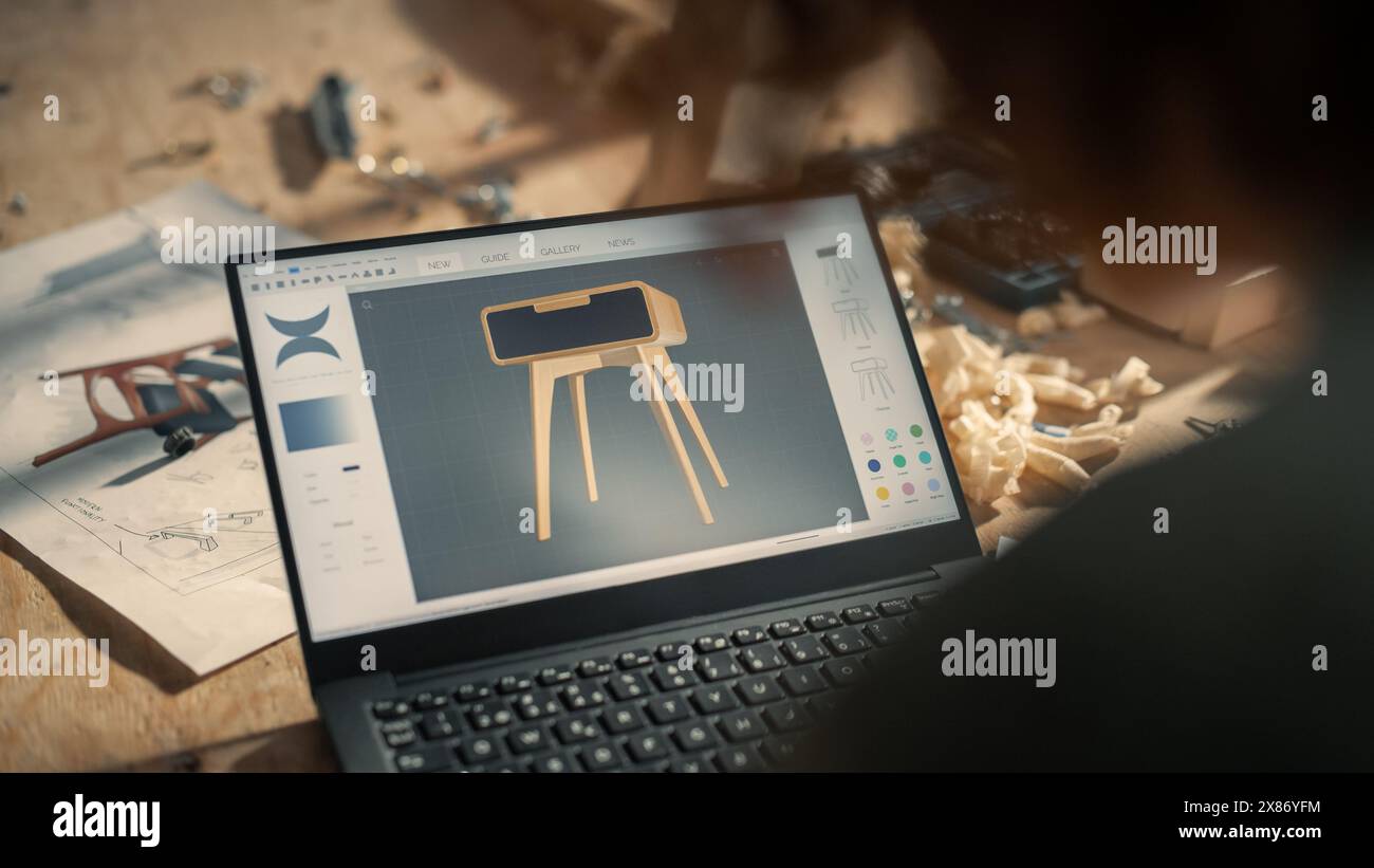 Over the Shoulder Shot of a Furniture Designer Working on Laptop ...