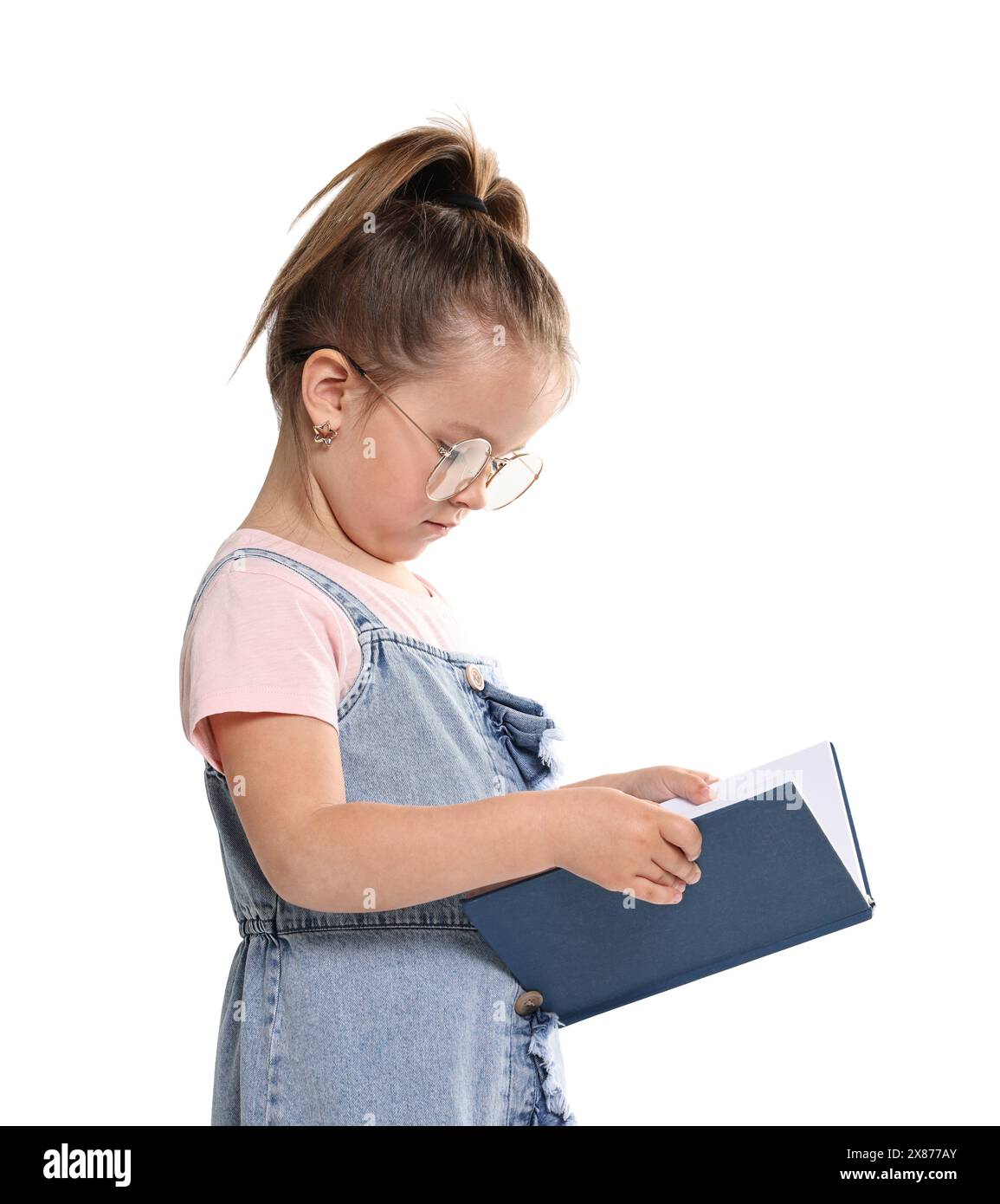 Cute little girl reading book on white background Stock Photo - Alamy