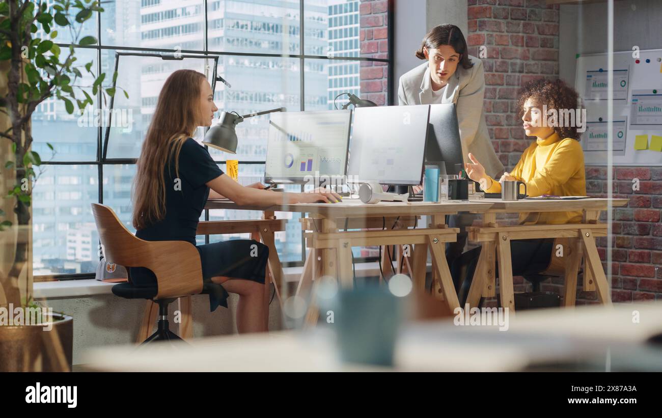 Creative Multicultural Colleagues Collaborate on a Project and Work Together as a Team. Marketing Manager and Designer Talking and Discussing Changes to an Advertising Campaign for a Startup. Stock Photo
