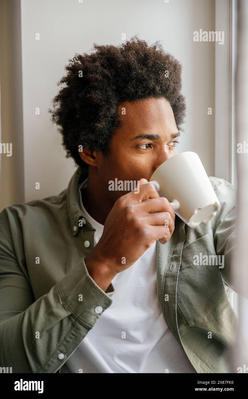 Man drinking from coffee cup at home Stock Photo