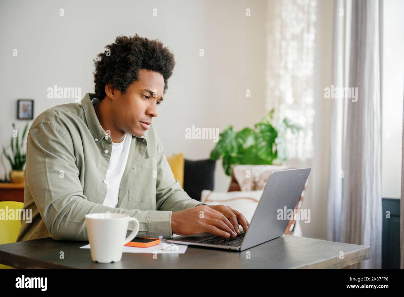 Businessman using laptop typing at table working from home Stock Photo