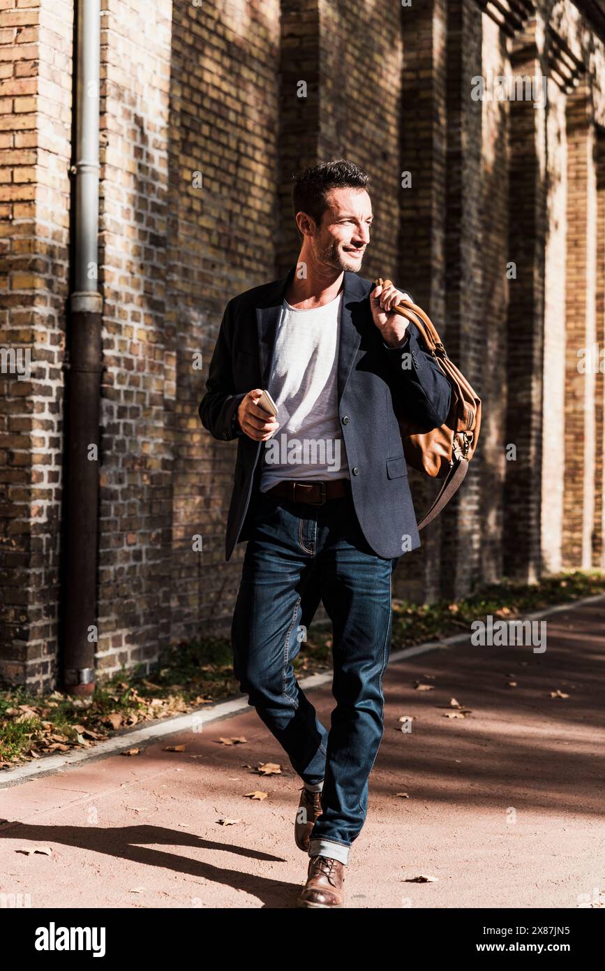 Handsome man walking on hi-res stock photography and images - Alamy
