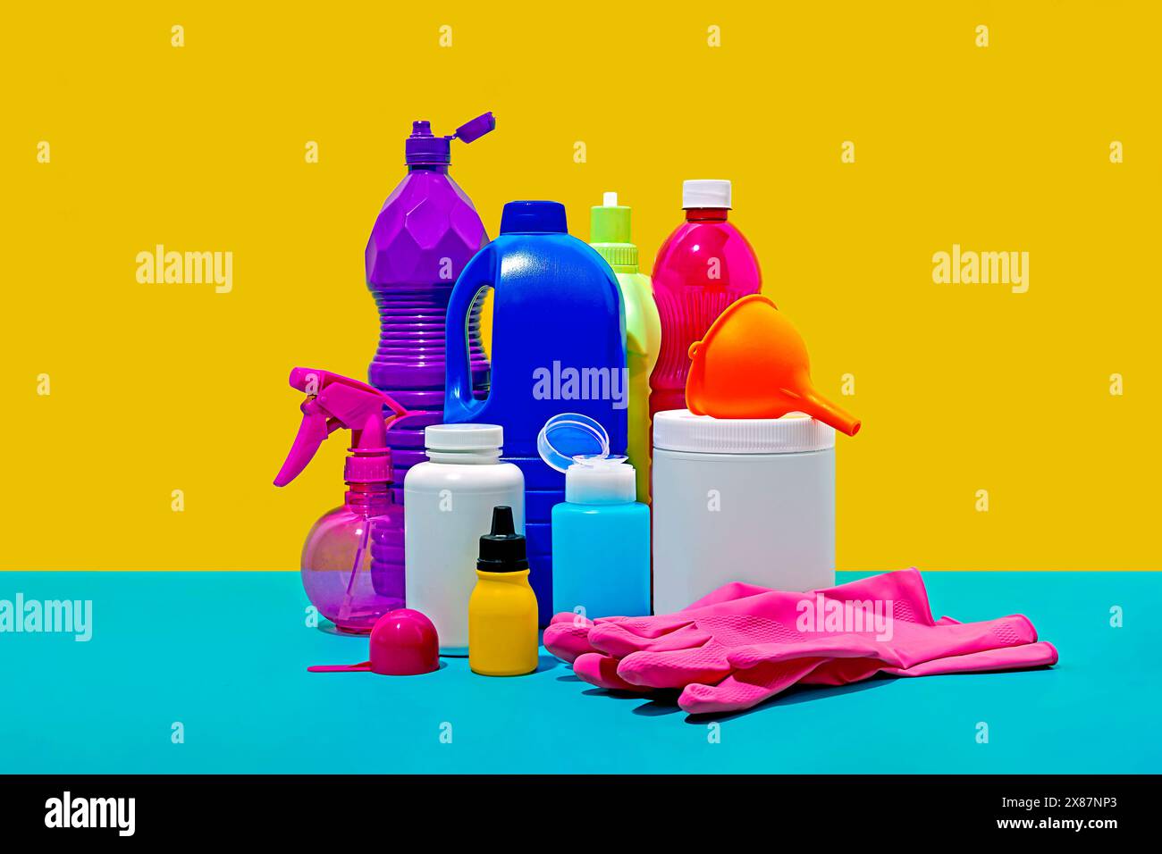 Still life of household cleaning products against yellow background Stock Photo