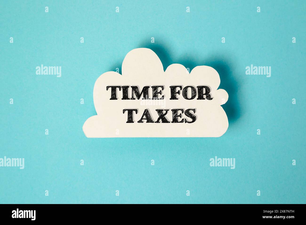 A white cloud with the word time for taxes written in black Stock Photo