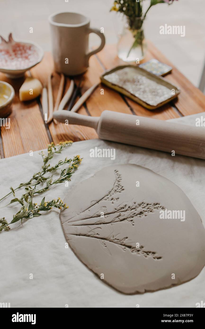 Clay with imprint of flowers on table at home Stock Photo
