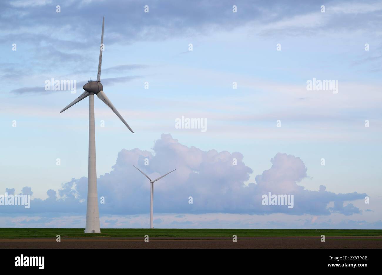 Wind turbines under cloudy sky Stock Photo - Alamy