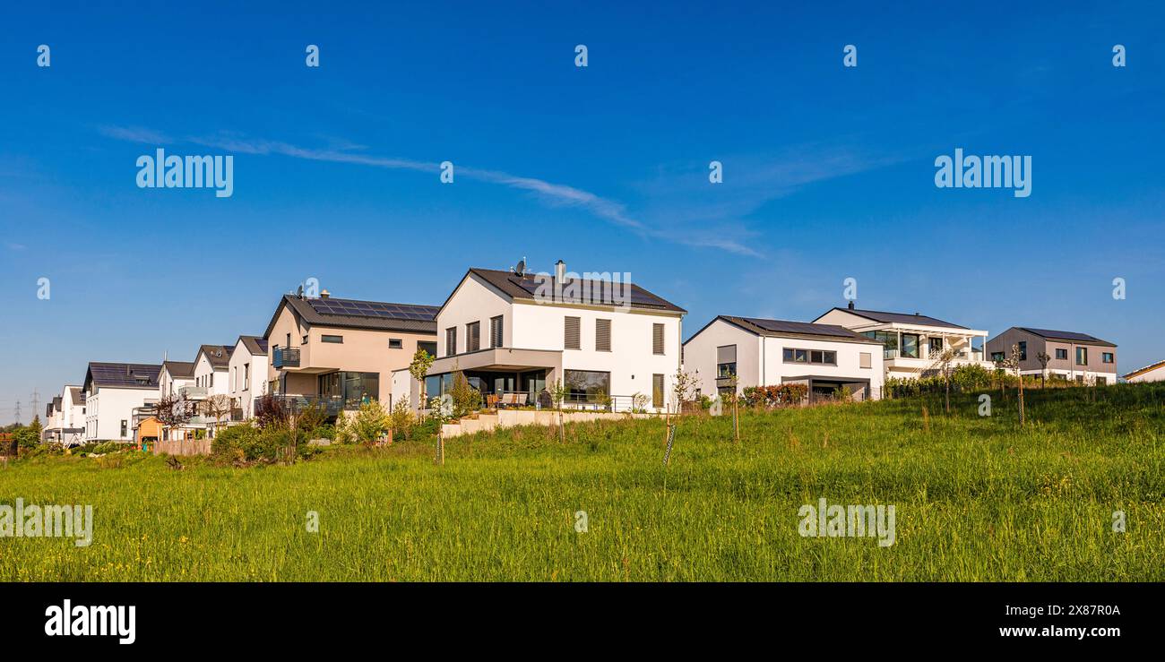 Germany, Baden-Wurttemberg, Waiblingen, Summer meadow in front of new development area Stock Photo