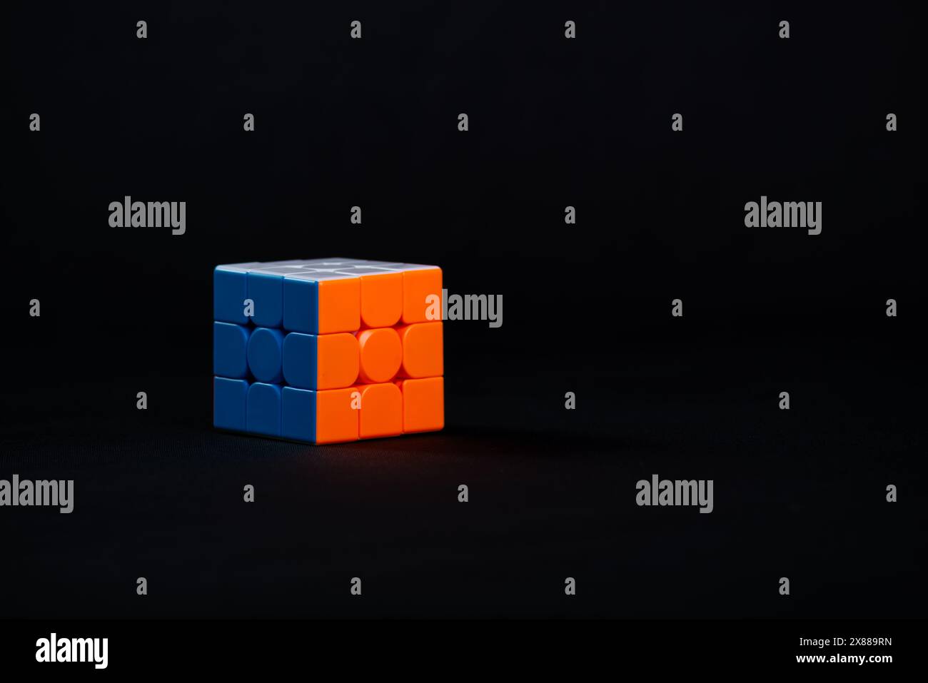Salvador, Bahia, Brazil - May 15, 2024: Classic 3x3x3 Rubiks Cube on a black background. Rubiks Cube invented by Hungarian architect Erno Rubik in 197 Stock Photo