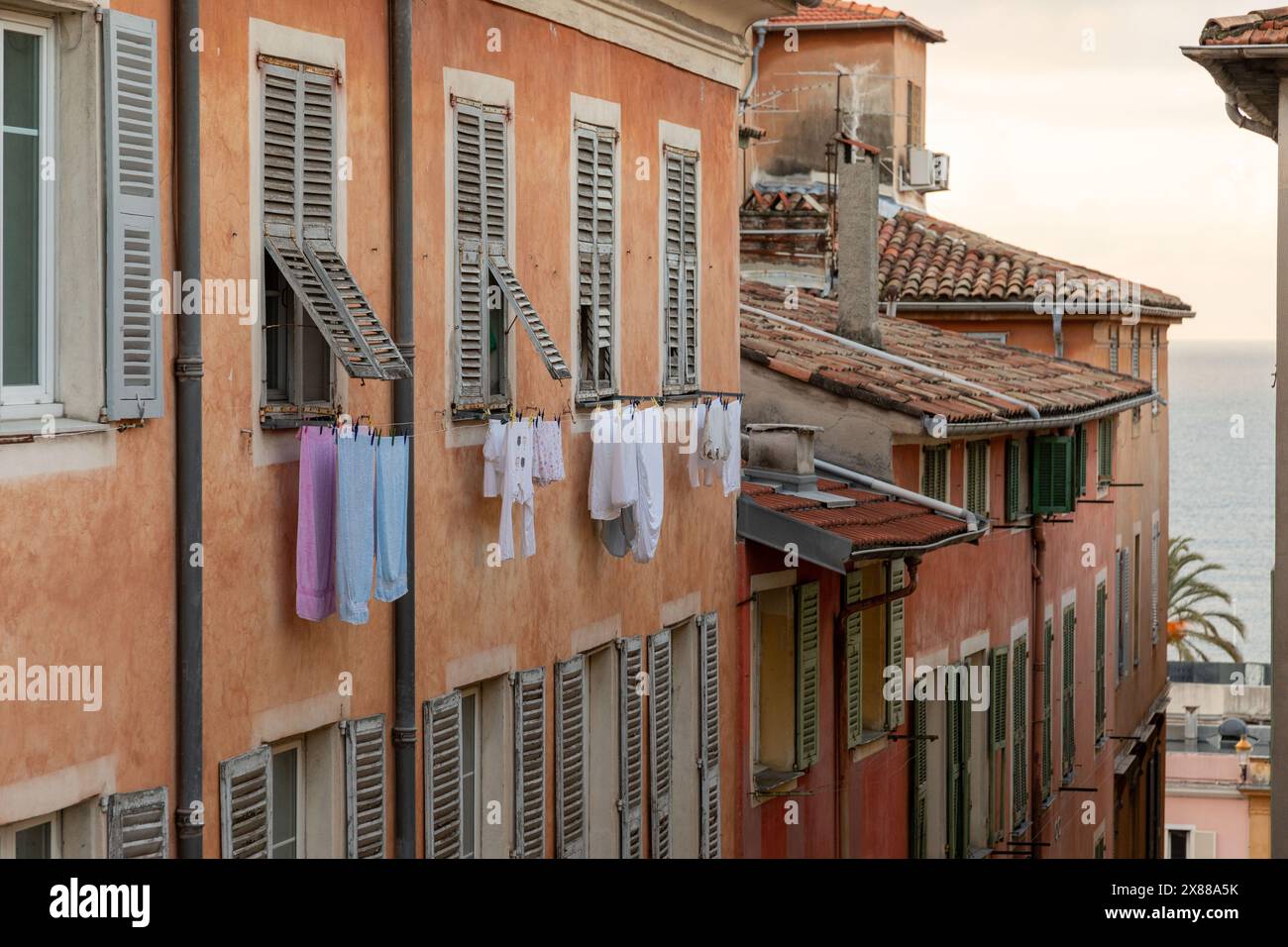 cloths hung on a clothsline to dry, outside an aparatment window, old town Stock Photo