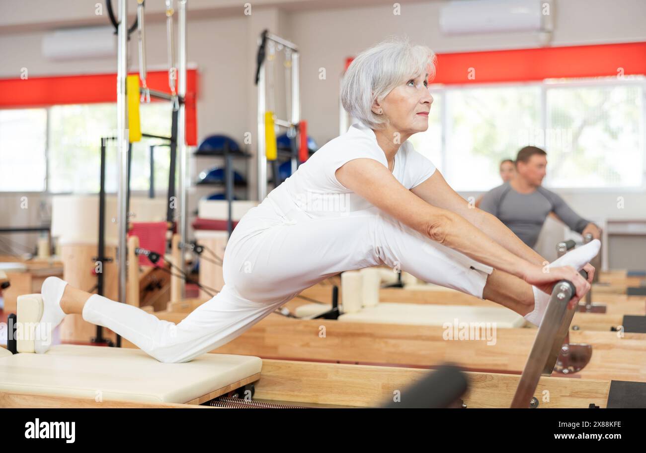 Image result for Senior woman performs exercise on reformer to improve coordination ...