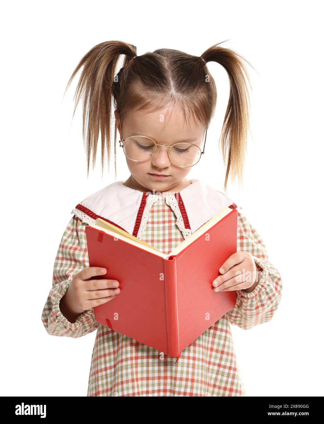 Cute little girl reading book on white background Stock Photo - Alamy