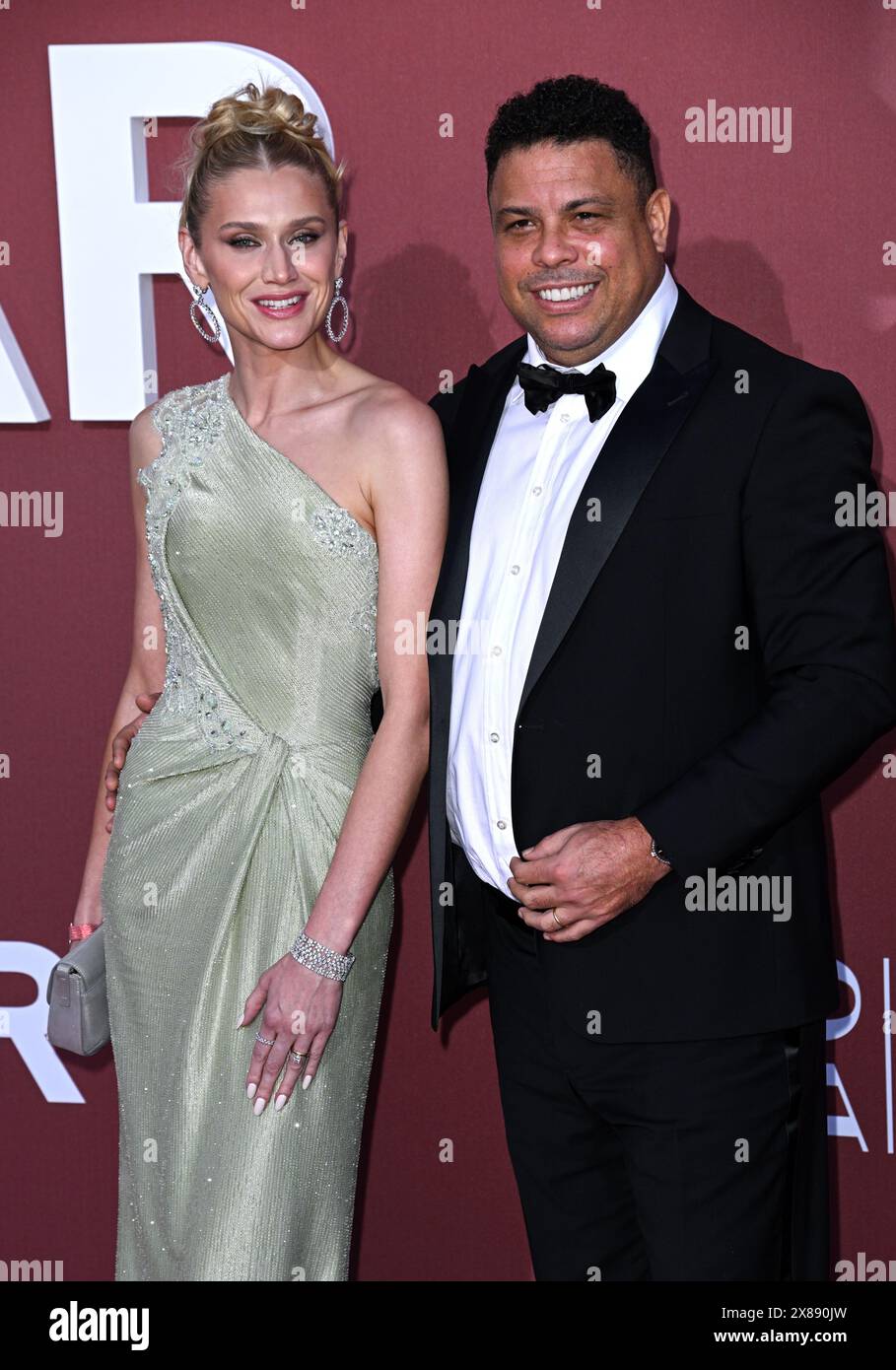Cannes, France. May 23rd, 2024. Celina Locks and Ronaldo Luís Nazário de Lima arriving at the 2024 amfAR Gala Cannes, Hotel du Cap Eden Roc. Part of the 77th edition of The Cannes Film Festival. Credit: Doug Peters/EMPICS/Alamy Live News Stock Photo