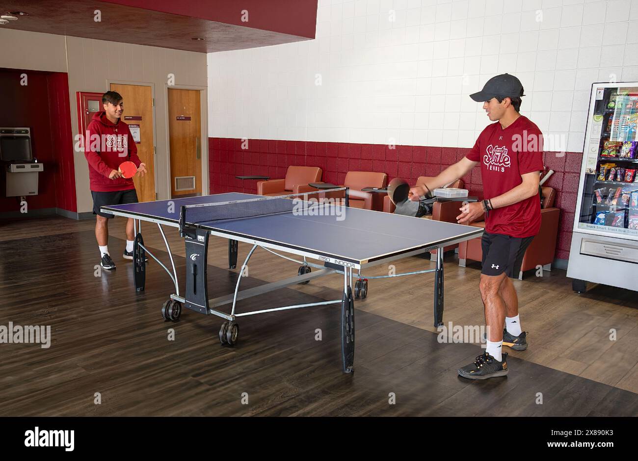 Ping pong or table tennis action by two NMSU students indoors at the American Indian student Center, Las Cruces, NM, USA Stock Photo