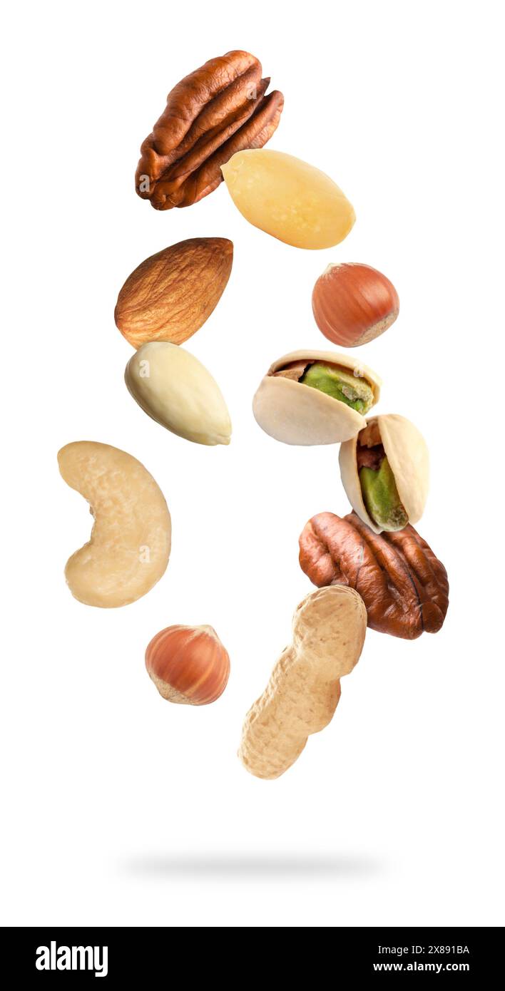 Many different nuts in air on white background Stock Photo
