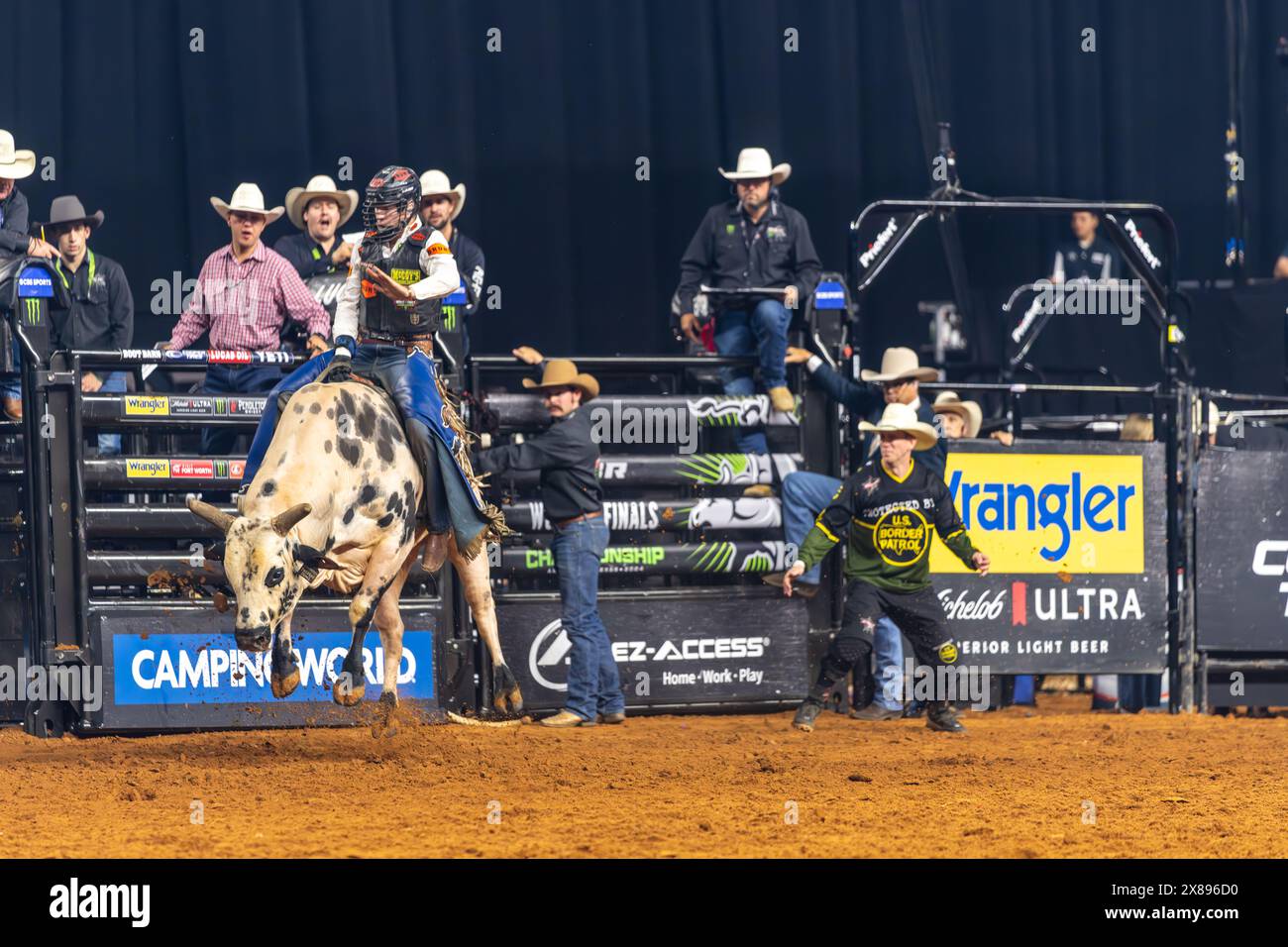 PBR World Finals 2024 in Dallas, Texas Bullfighter hanging on for eight seconds Stock Photo