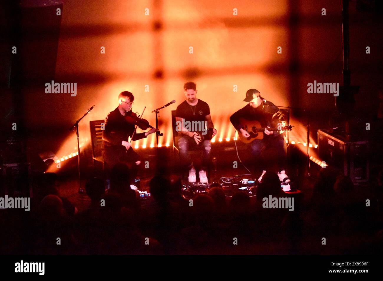 Coldplay performing live in concert, showcasing their genre-blending music in 2021